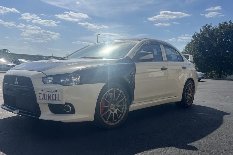 White Mitsubishi Evo with custom plate